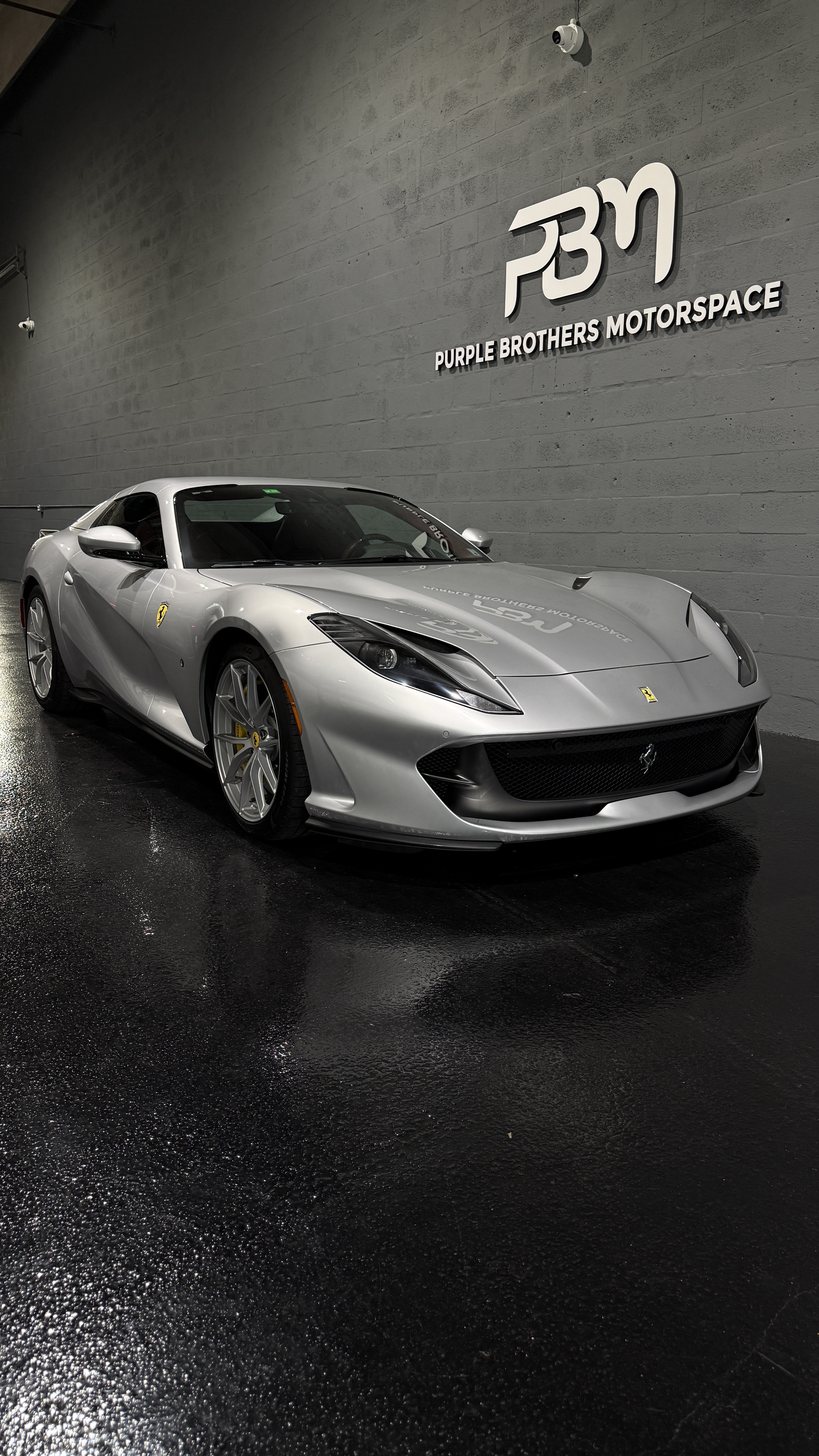Ferrari with cinematic lighting in the Purple Brothers showroom